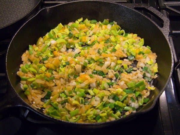 frying rice, kimchi and vegeatbles in a skillet