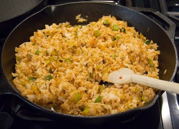 step by step making fried rice in a cast iron skillet