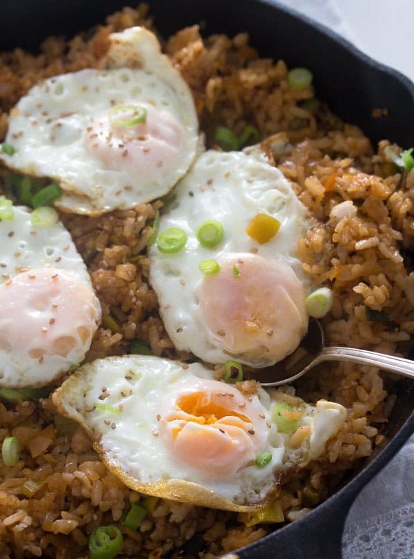 full skillet with fried rice and four fried eggs