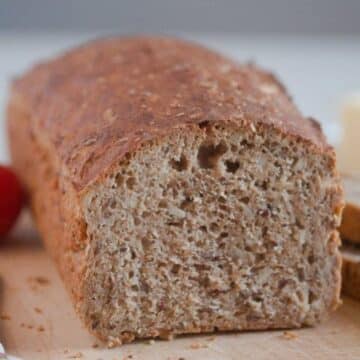 a loaf of spelt bread, cut to show the crumb.