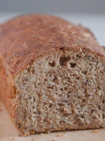 a loaf of spelt bread, cut to show the crumb.
