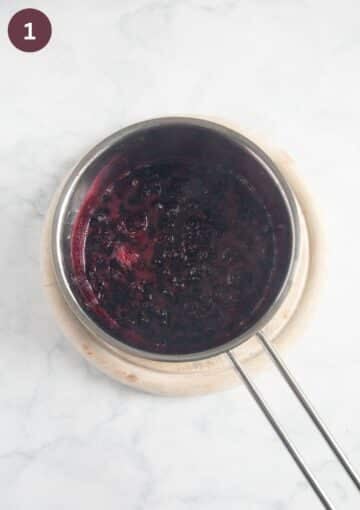 cooked berries in a small saucepan needed to make puff pastry cake.