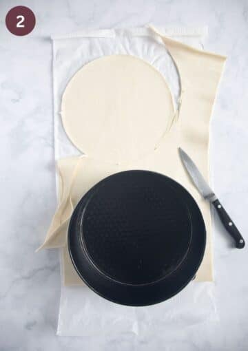 cutting circles of puff pastry using a small springform and a knife.