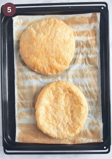 two golden baked circles of puff pastry on a lined baking sheet.