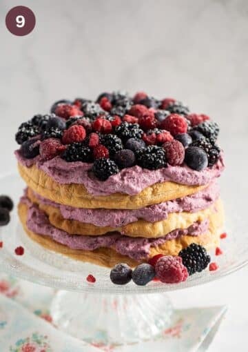 puff pastry cake layered with whipped cream mixed with berry puree and topped with fresh berries.