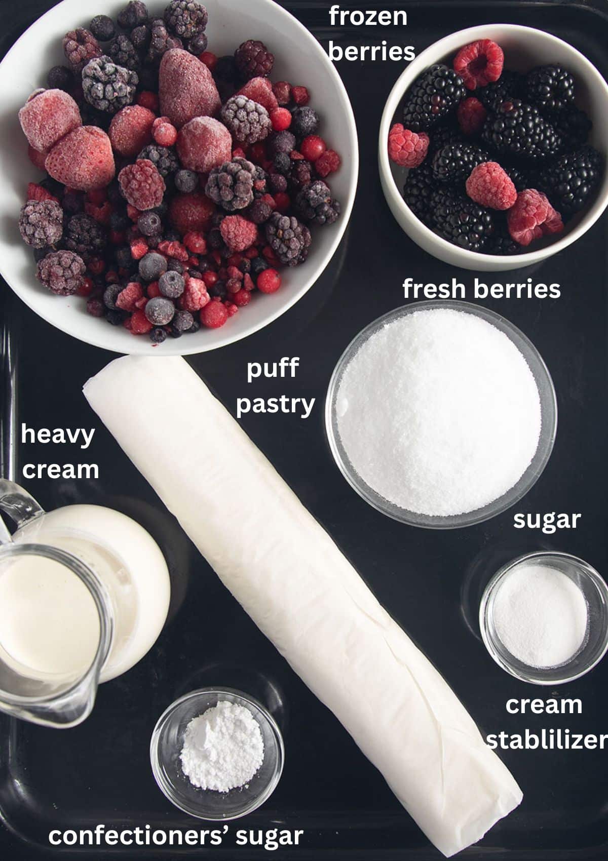 labeled ingredients for making cake with puff pastry, berries, heavy cream, sugar.