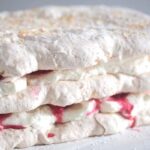 layers of meringue filled with cream and runny raspberries