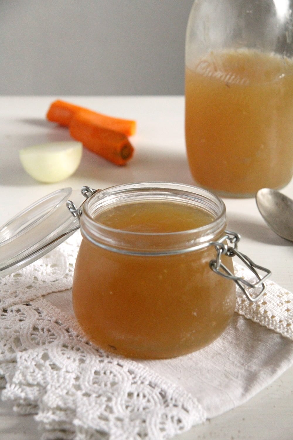 golden bone broth in a jar and a bottle