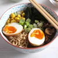 ramen soup with soy sauce eggs and noodles in a bowl