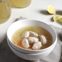 salmon dumplings soup in a white bowl