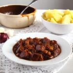 spanish stew with pork served with potatoes