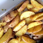 potato wedges in a roasting tin