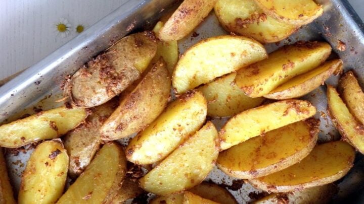 potato wedges in a roasting tin