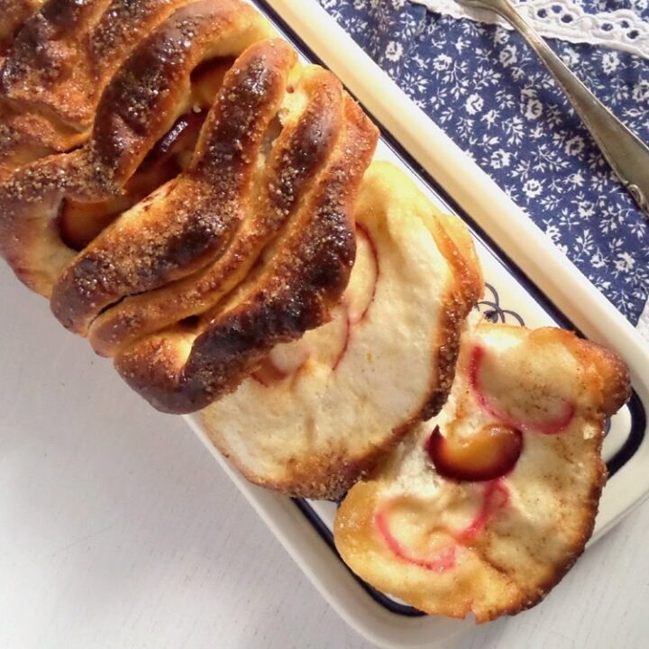 plum bread with cinnamon on a blue tablecloth