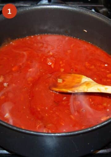 stirring red sauce for enchiladas with a wooden spoon in a pot.