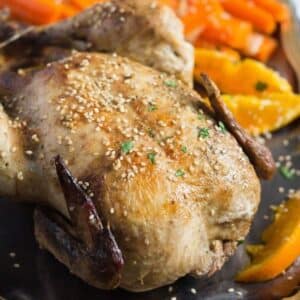 roasted chicken with oranges close up.