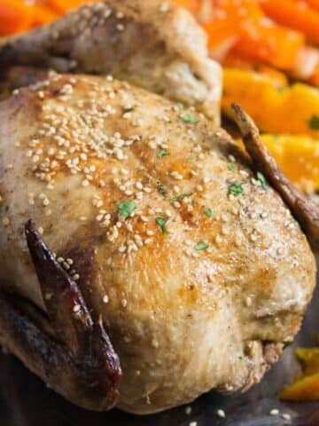 roasted chicken with oranges close up.