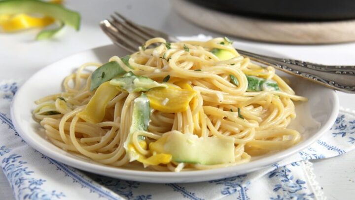 plate with yellow pasta with cream and zucchini
