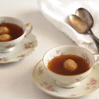 vintage cups filled with roasted vegetable broth.