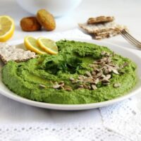 wild garlic spread with sunflower seeds and lemon on a plate