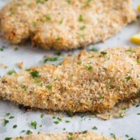 crispy baked parmesan crusted chicken on parchment paper