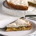 slice of german rhubarb pie with meringue on a small plate.