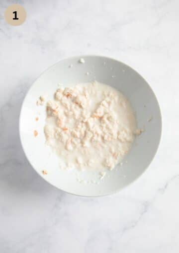 bread soaking in milk needed to make meatloaf in a bowl.