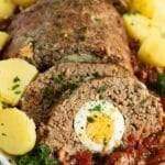 pin image with the title meatloaf with egg inside.