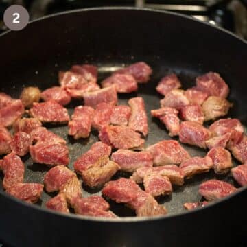 meat pieces browning in a pan for making goulash.