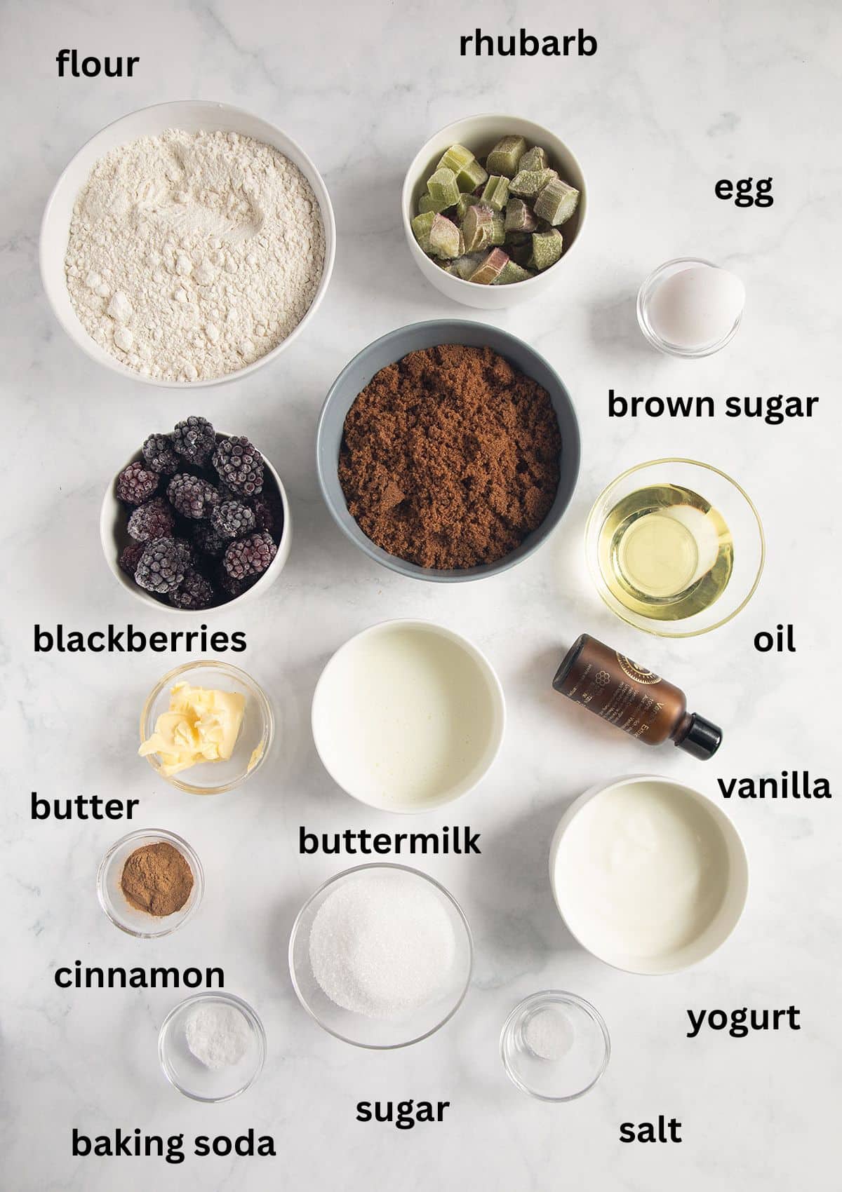 labeled ingredients for making a loaf cake with rhubarb and blackberries. 