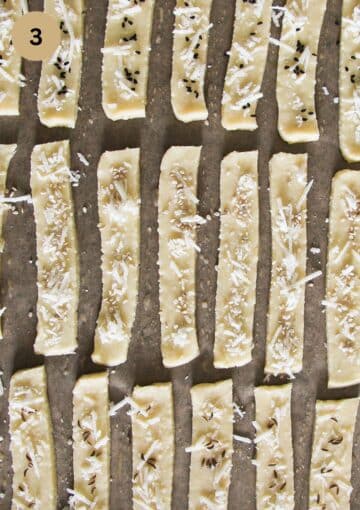 unbaked crackers or saratele sprinkled with cheese and caraway cheese.