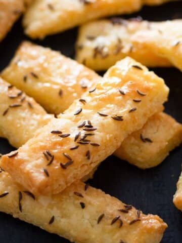 romanian saratele sprinkled with caraways seeds and cheese.