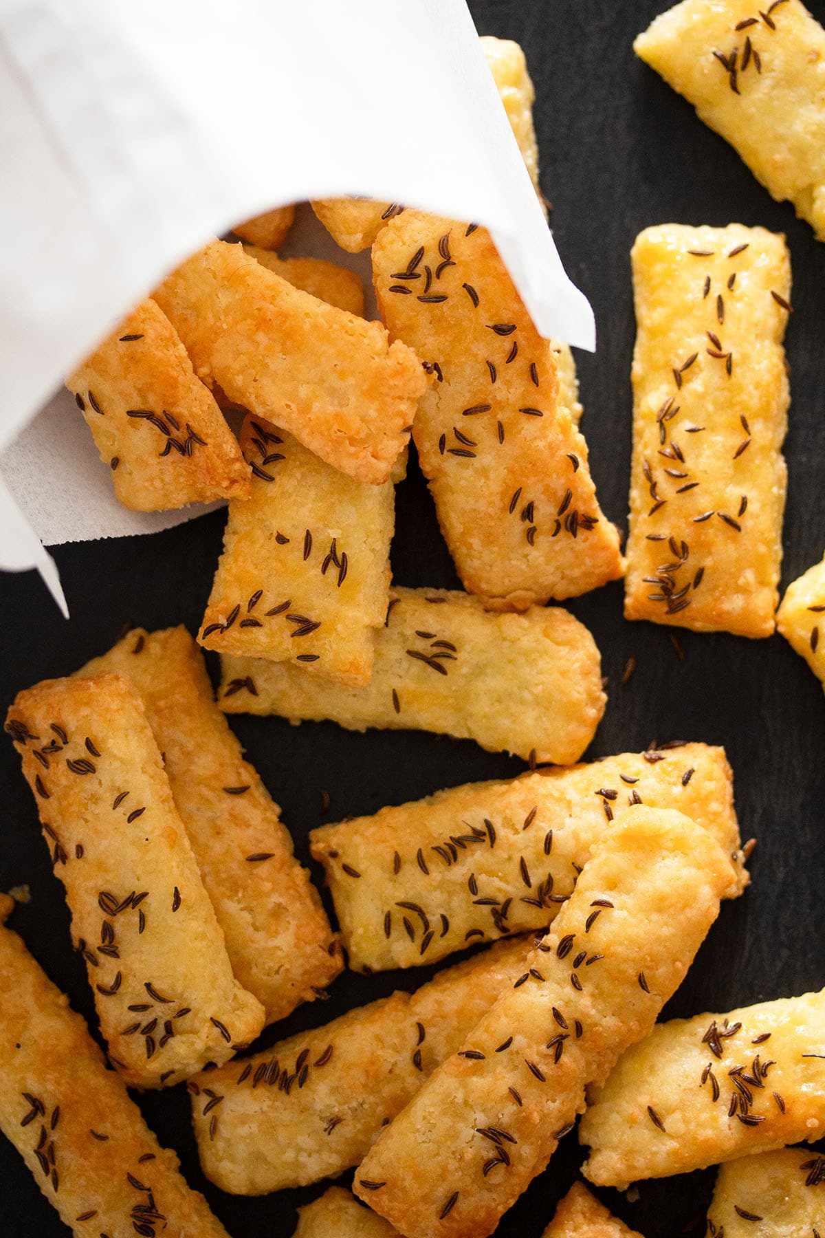 a white paper bag and many romanian saratele on a black board.