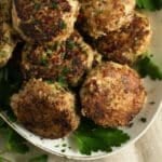 turkey meatballs no breadcrumbs and parsley leaves on a serving platter.