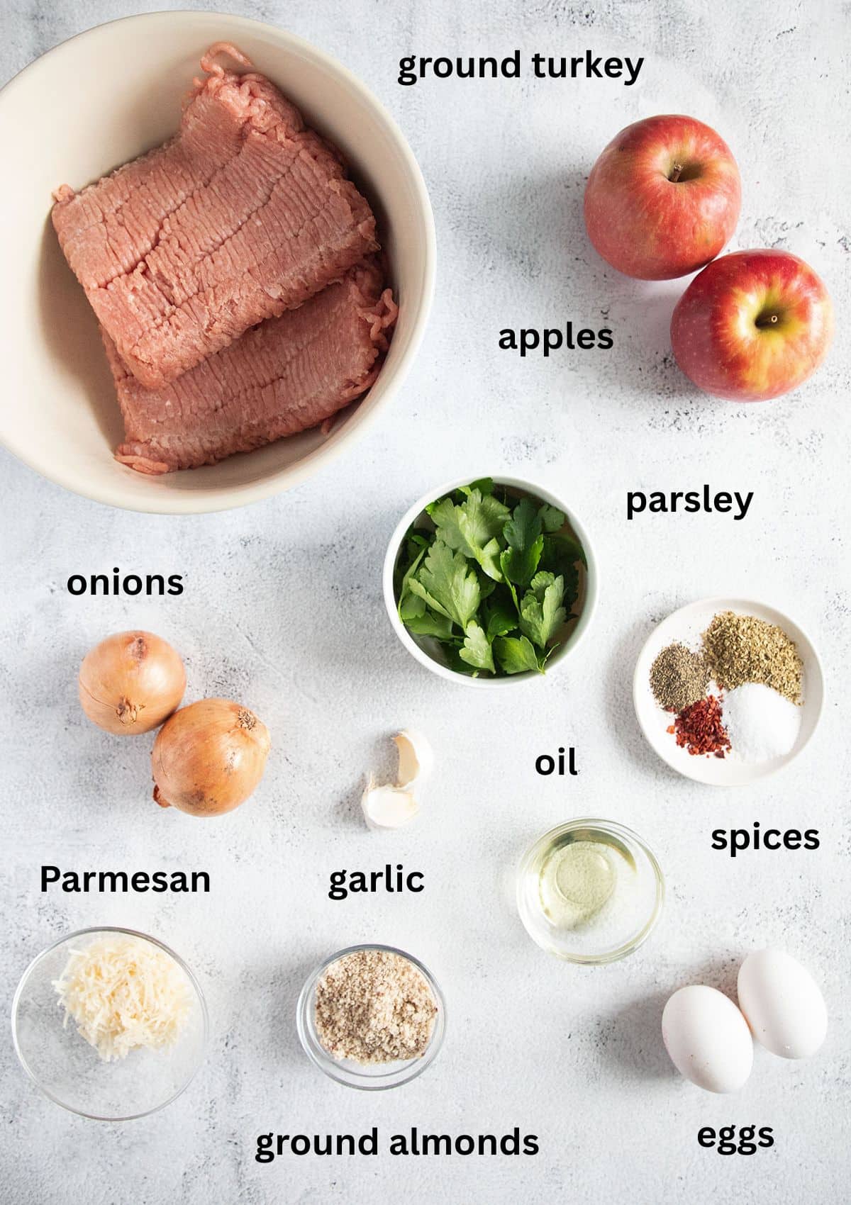 labeled ingredients for making turkey meatballs without breadcrumbs but with apples, ground almonds and spices.