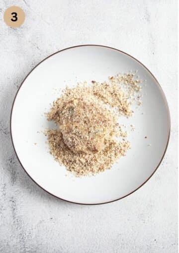 coating a turkey meatballs with ground almonds.