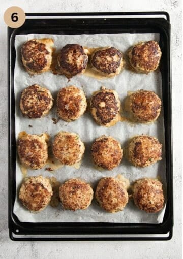 baked turkey meatballs on a baking sheet lined with parchment paper.