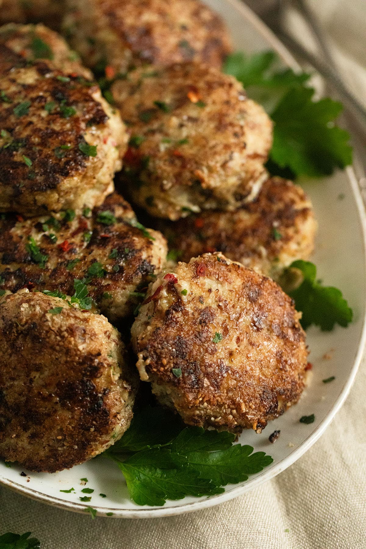 turkey meatballs without meatballs garnished with parsley leaves on a platter.