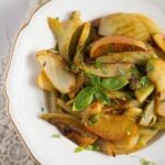 braised fennel with apples on a white vintage plate.