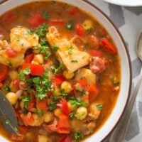 bowl of spanish chicken and chorizo stew with peppers and chickpeas