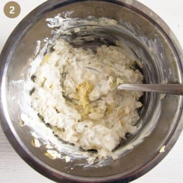 sitrring cream cheese and grated garlic in a bowl to make spinach dip.