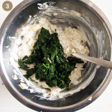 stirring cooked spinach in a bowl with cream cheese and yogurt.