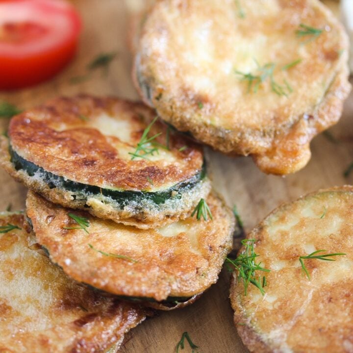 pan fried zucchini slices on a serving board