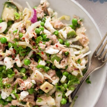 close up salad with fish, feta and peas.