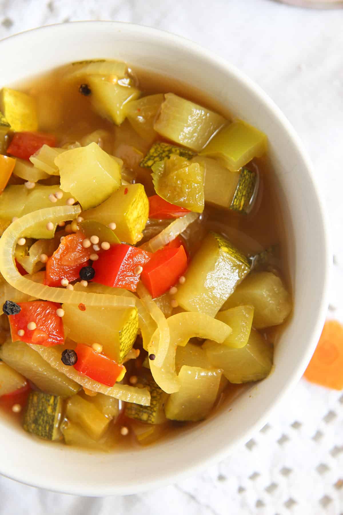 zucchini pickles with onions and peppers in a bowl.