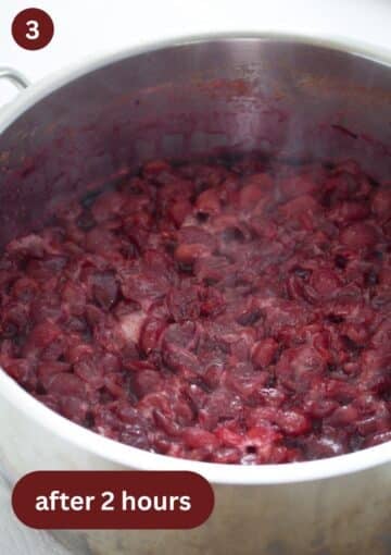 cherries cooked for 2 hours to make cherry butter in a large pot.