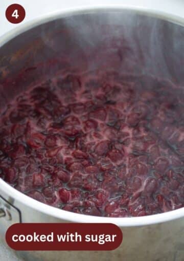 cherries cooked with sugar to make cherry butter in a large pot.