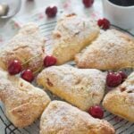 fresh cherry scones served with icing sugar and coffee.