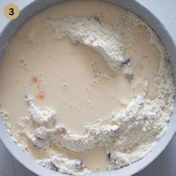 adding milk to dough to make scones in a bowl.