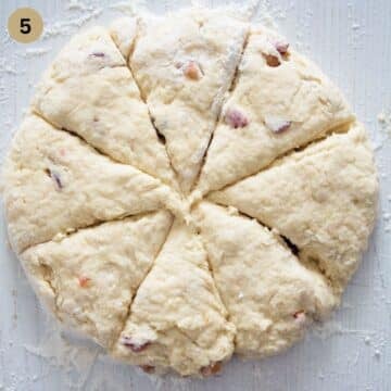 a circle of dough cut into triangles to make cherry scones.